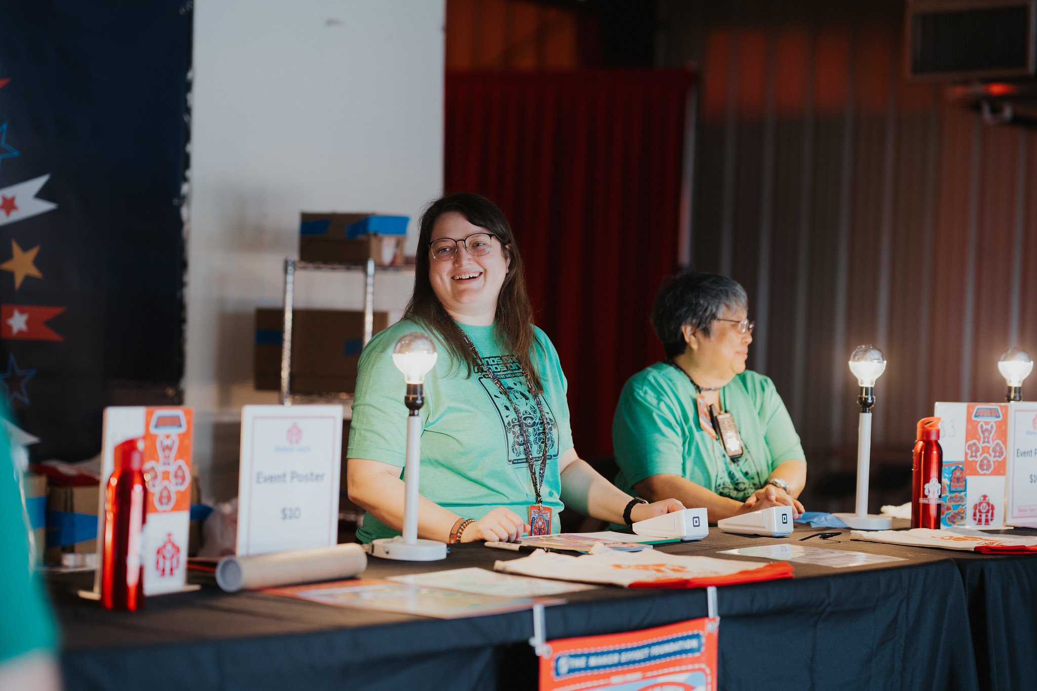 Crew members running the Maker Faire Orlando merch table